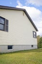 House with pale yellow vinyl siding