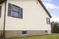 House with pale yellow vinyl siding