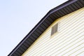 House with pale yellow vinyl siding