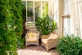 House patio with wicker chairs and green plants