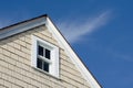 House peak with window and blue sky