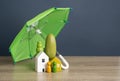 House with people under an umbrella. Property insurance.