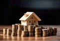 house perched on a stack of coins, symbolizing the financial concept of investment, savings, and real estate.