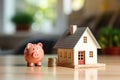 House and pig piggy bank with coins. Real estate and savings.