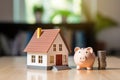 House and pig piggy bank with coins. Real estate and savings.