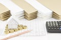 House on pile of gold coins as triangle with pencil Royalty Free Stock Photo
