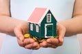 House on a pile of money in woman hands Royalty Free Stock Photo