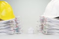 House between pile overload document have engineer hat on top Royalty Free Stock Photo