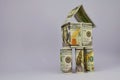 House on pillars in a light blue background, made of 100 dollar bills Royalty Free Stock Photo