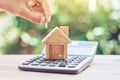 House is placed on the calculator. hand that is coin down the house. planning savings money of coins to buy a home Royalty Free Stock Photo