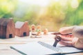 House placed on coins Men`s hand is planning savings money of coins to buy a home Royalty Free Stock Photo