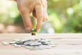 House placed on coins Men`s hand is planning savings money of coins to buy a home Royalty Free Stock Photo