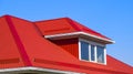 House with plastic windows and a red roof of corrugated sheet Royalty Free Stock Photo