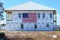 American flag on the side of a Hurricane Damaged Home