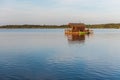 A house on a raft in Lielauce Lake. Royalty Free Stock Photo