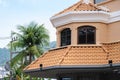 House with red clay tiled roof and gable and valley type of roof construction Royalty Free Stock Photo