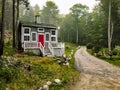 House with a Red Door on a Dirt Road Royalty Free Stock Photo