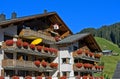 House with red geraniums on the balconies