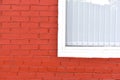 A house with a red painted brick wall and white Windows Royalty Free Stock Photo