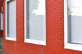 A house with a red painted brick wall and white Windows Royalty Free Stock Photo