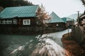 a house with a red roof is near a wood fence Royalty Free Stock Photo