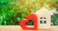 House with a red wooden heart. House of lovers. Affordable housing for young families. Valentine`s day house.