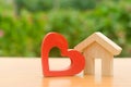 House with a red wooden heart. House of lovers. Affordable housing for young families, support program. Parental hospitable home. Royalty Free Stock Photo