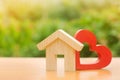House with a red wooden heart. House of lovers. Parental hospitable home. Housing construction of your dreams. Buying and renting Royalty Free Stock Photo
