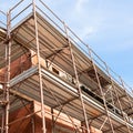 House for renovation with the scaffolding for bricklayers Royalty Free Stock Photo