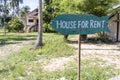 House for rent real estate sign in front of tropical house in island Koh Phangan, Thailand. Houses offered for rent to tourists Royalty Free Stock Photo