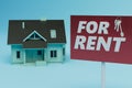 house rental concept. the house next to which the sign is for rent on a blue background. 3d render Royalty Free Stock Photo