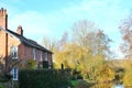 house resting by river in English countryside Royalty Free Stock Photo