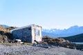 House on river with mountains at back. Royalty Free Stock Photo