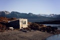 House on river with mountains at back. Royalty Free Stock Photo