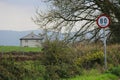 House on Roadside in Ireland with speed sign 80 km/h