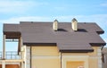 House roof with Asphalt shingles, ventilation, chimney and roof gutter pipeline outdoors.