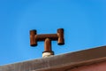 House roof with chimney made with rusty pipes - Italy