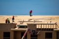 House roof. Roofing construction. Roofer using air nail. Roofing tiles of the new roof under construction building