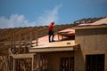 House roof. Roofing construction. Roofer using air nail. Roofing tiles of the new roof under construction building