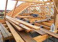 House roofing construction panorama. Installing wooden rafters, eaves, waterproofing logs with bitumen