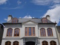 House with round topped brown casement windows