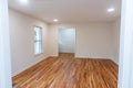 A house for sale with an empty white room of a newly renovated and painted house with dark hardwood floors Royalty Free Stock Photo