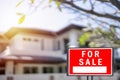 House for sale. Left facing red for sale sign outside Royalty Free Stock Photo