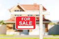 House for sale, red sign in front of blurred modern big building on grass Royalty Free Stock Photo