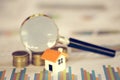 House searching concept with a magnifying glass, house and money. magnifying glass and coins. concept of mortgage, construction,