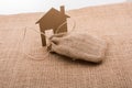 House shape cut out of paper beside a sack