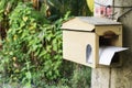 A house shape wooden mailbox hanging on a tree Royalty Free Stock Photo