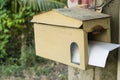 A house shape wooden mailbox hanging on a tree Royalty Free Stock Photo