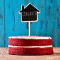 House-shaped chalkboard with the text congrats in a cake, with a