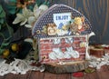 A house-shaped scrapbook with brick walls and black roof